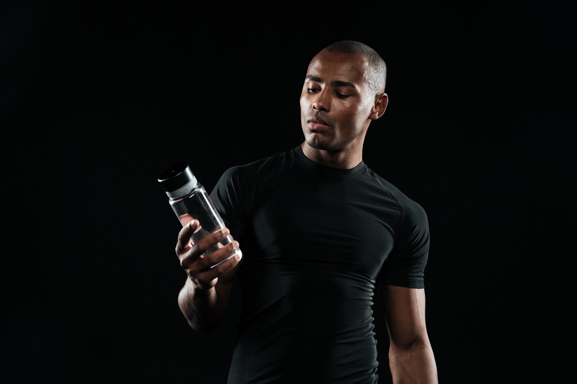 Fitness enthusiast using pre and post-workout supplements to enhance training results